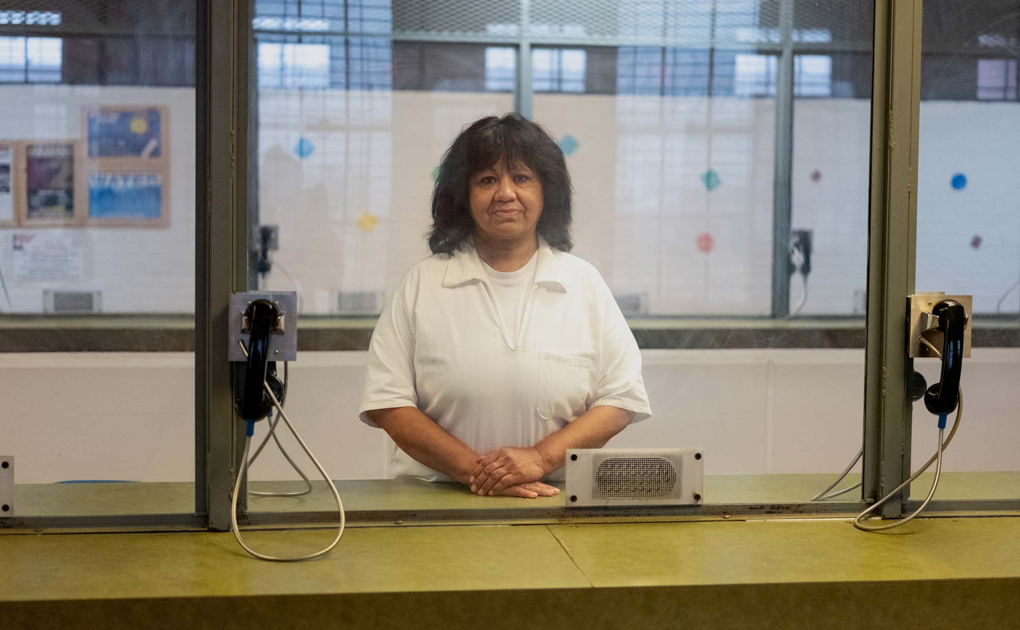 GATESVILLE, TEXAS - March 21, 2022: Melissa Lucio poses for a portrait behind glass at the Mountain View Unit in Gatesville, Texas. (Image: Ilana Panich-Linsman for The Innocence Project)
