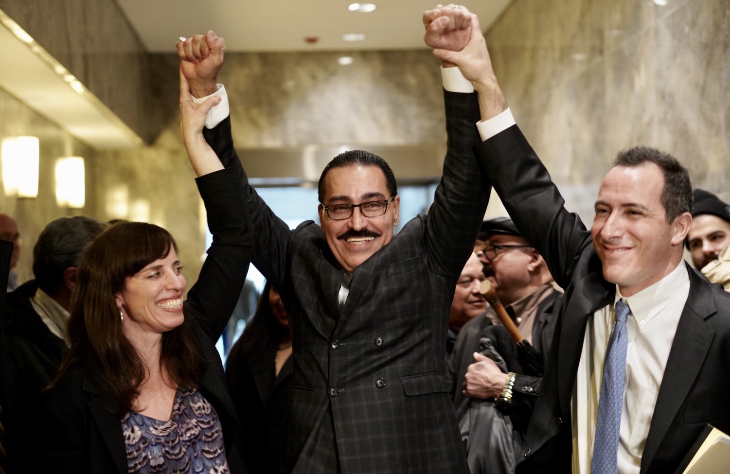 Felipe Rodriguez (center) after his hearing with his attorneys Nina Morrison, senior litigation counsel at the Innocence Project, (left), and Zachary Margulis-Ohnuma (right), at the Queens County Supreme Court on Dec. 30. Credit: Sameer Abdel-Khalek for the Innocence Project.